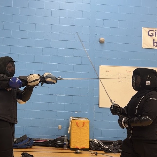 Olgun Tiltay learning Longsword blocks from Cosmas Cieplak-Mayr von Baldegg HEMA instructor in Ausardia